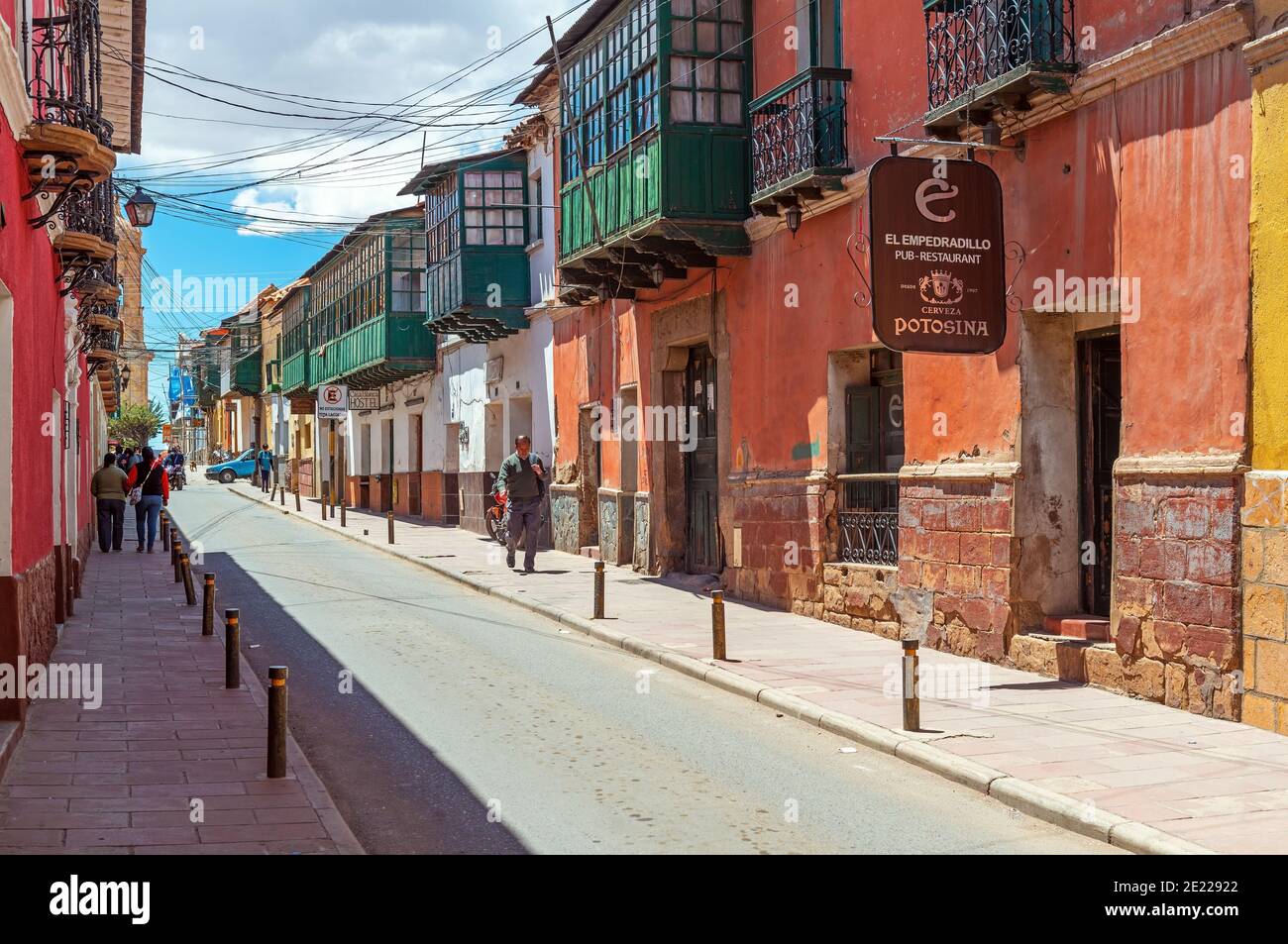 City life in a colonial style architecture street of Potosi with Bolivian people walking, Bolivia. Stock Photo