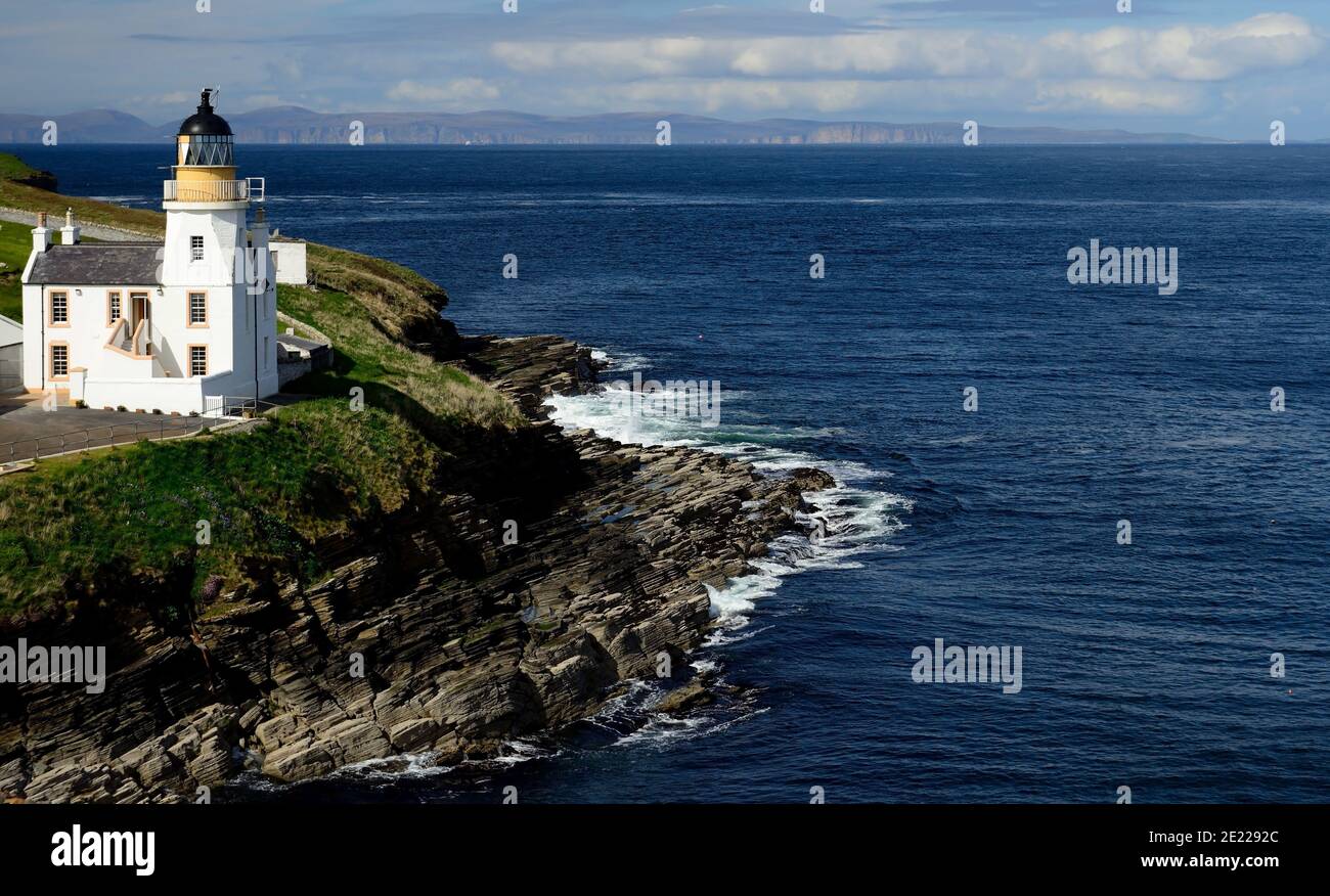 Holburn Head lighthouse, looking across the Pentland Firth towards the Orkney Islands. Stock Photo