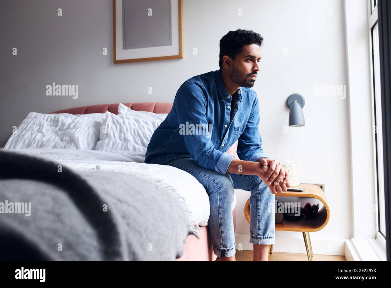 Man sitting on his bed hi-res stock photography and images - Alamy