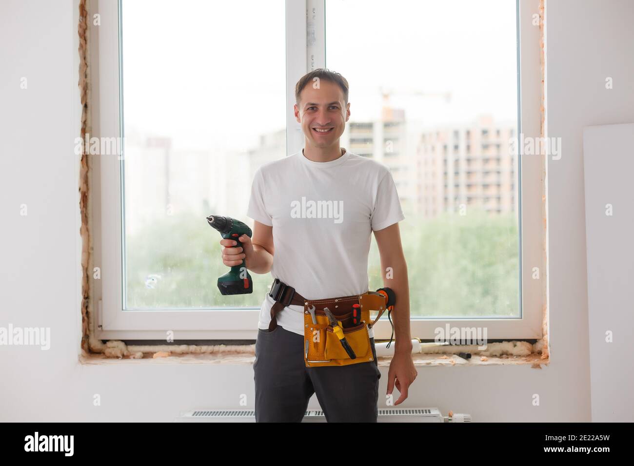 Young handyman repair window with screwdriver Stock Photo Alamy