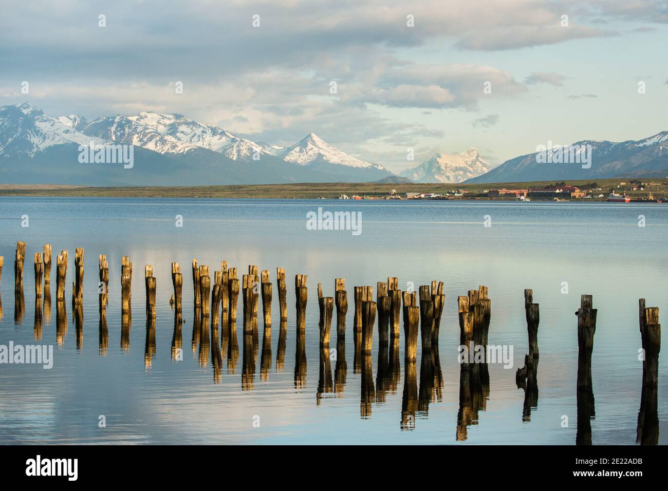 Old wooden jetty reflected in waters of the Ultima Esperanze Sound / Golfo Almirante Montt Puerto Natales, Patagonia, Chile, Andes & Torres del Paine Stock Photo