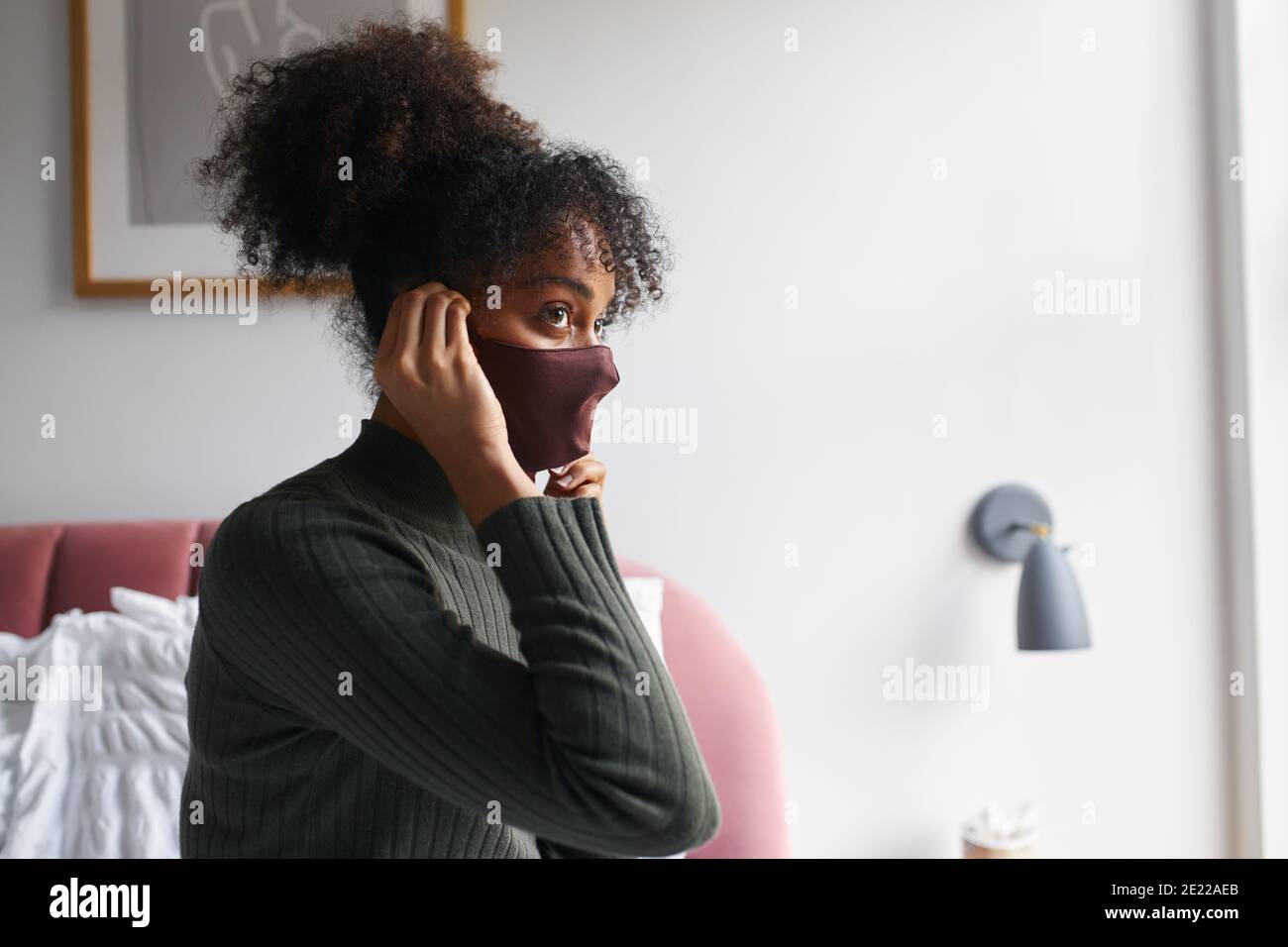 Woman putting on face mask hi-res stock photography and images - Alamy