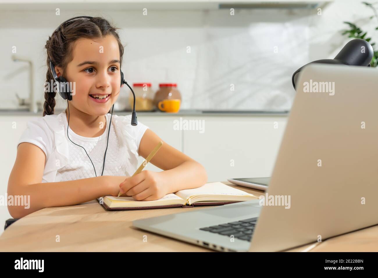 Kids distance learning. Cute little girl using laptop at home ...