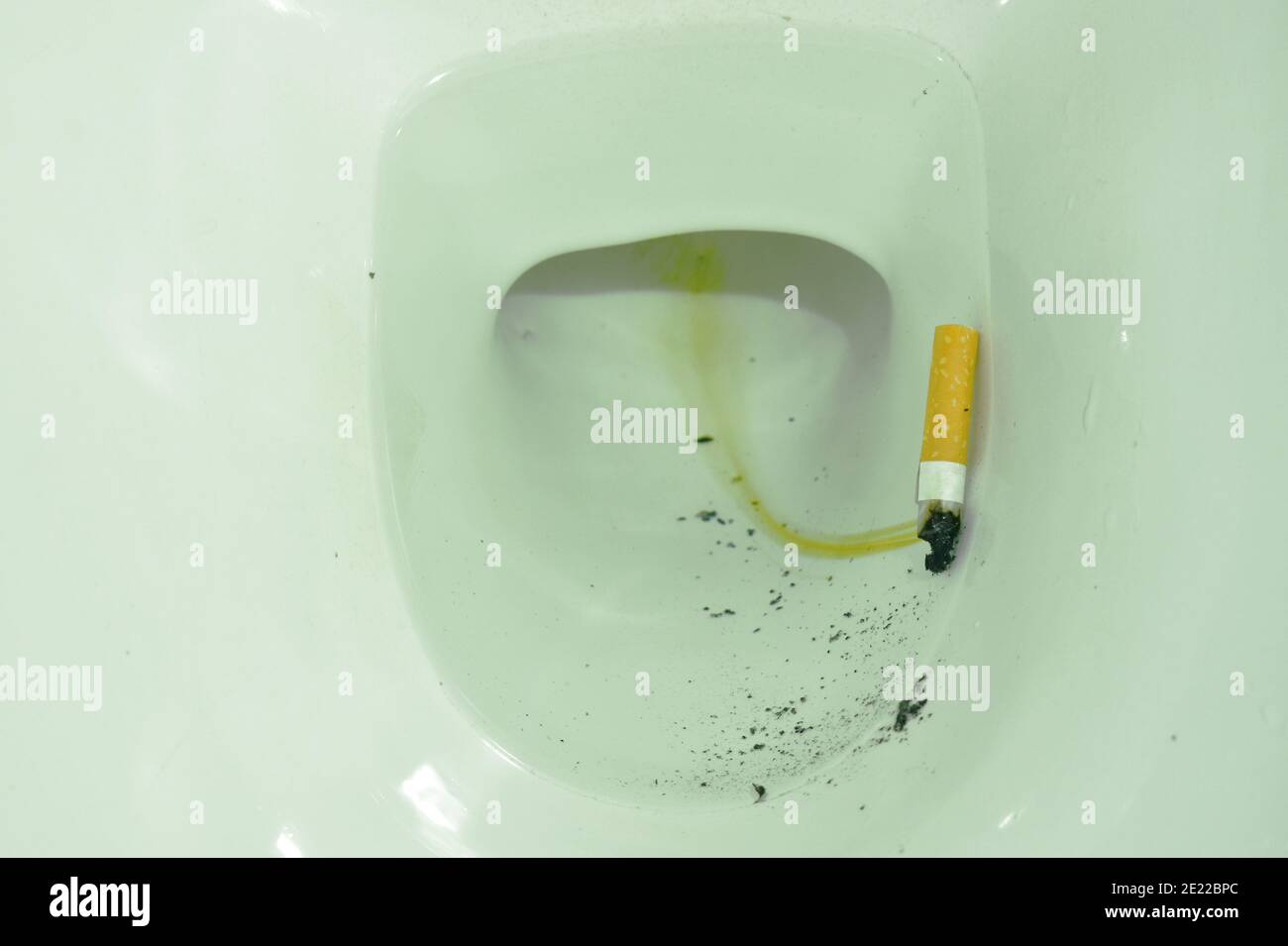 cigarette filter floating in toilet sewer hole Stock Photo