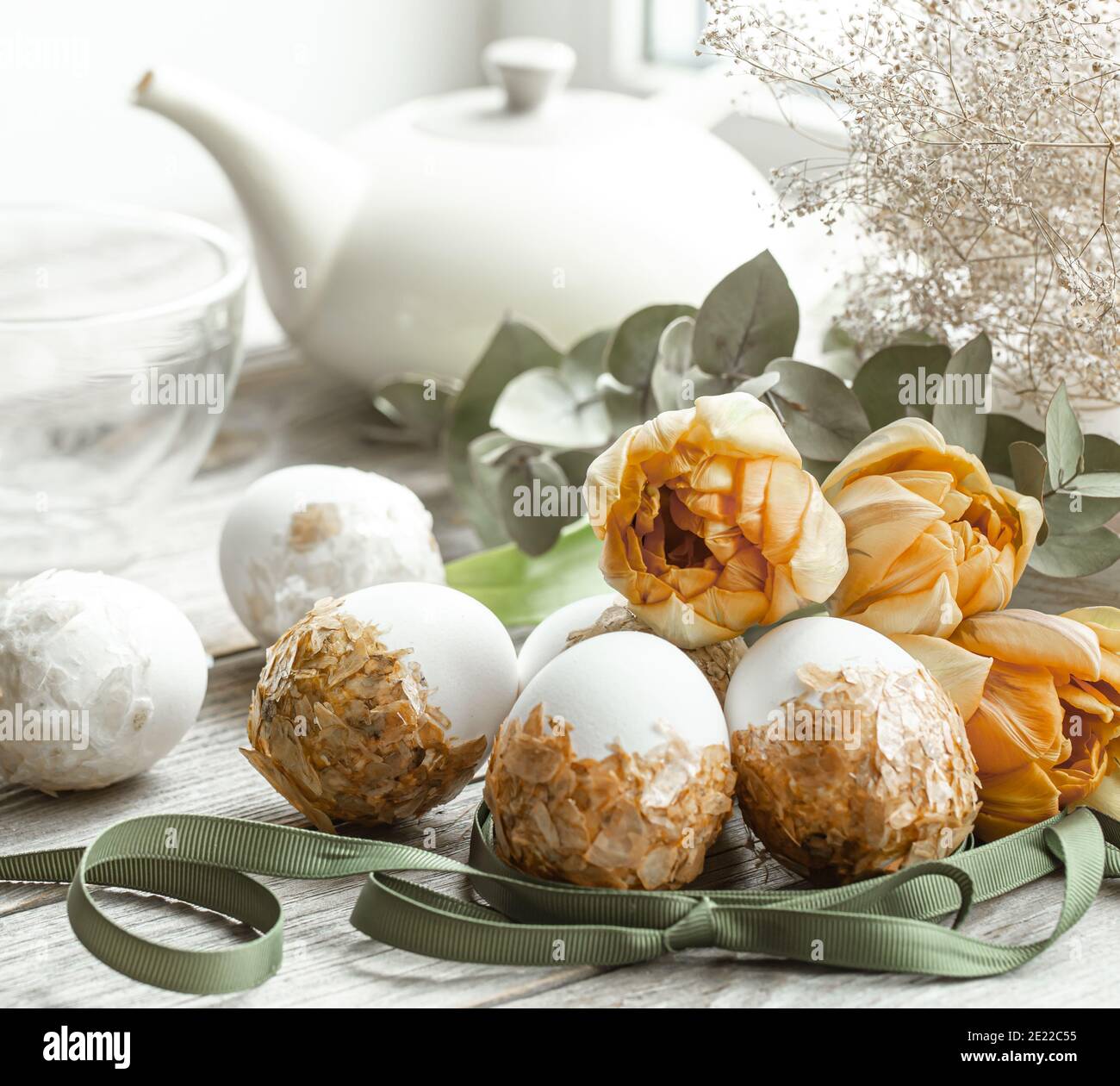 Festive composition for the Easter holiday with decorated eggs and fresh flowers. Stock Photo