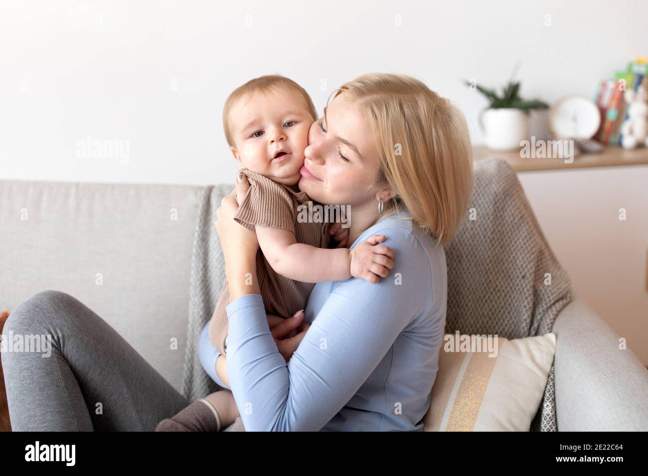 Affectionate young mother cuddling with her little baby Stock Photo Alamy