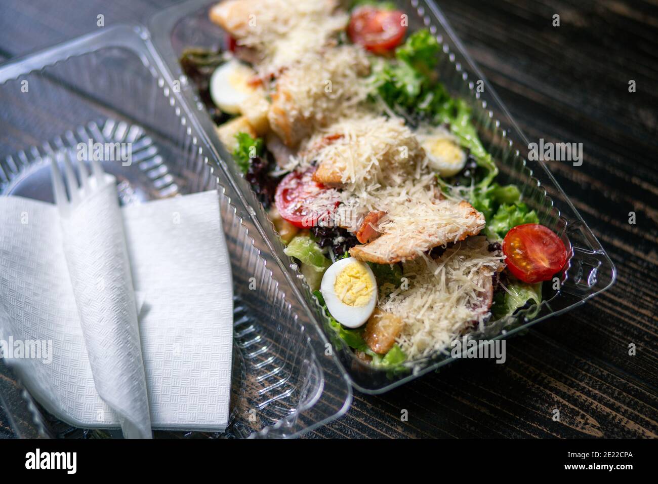 Cesar salad in plastic container for food delivery Stock Photo Alamy