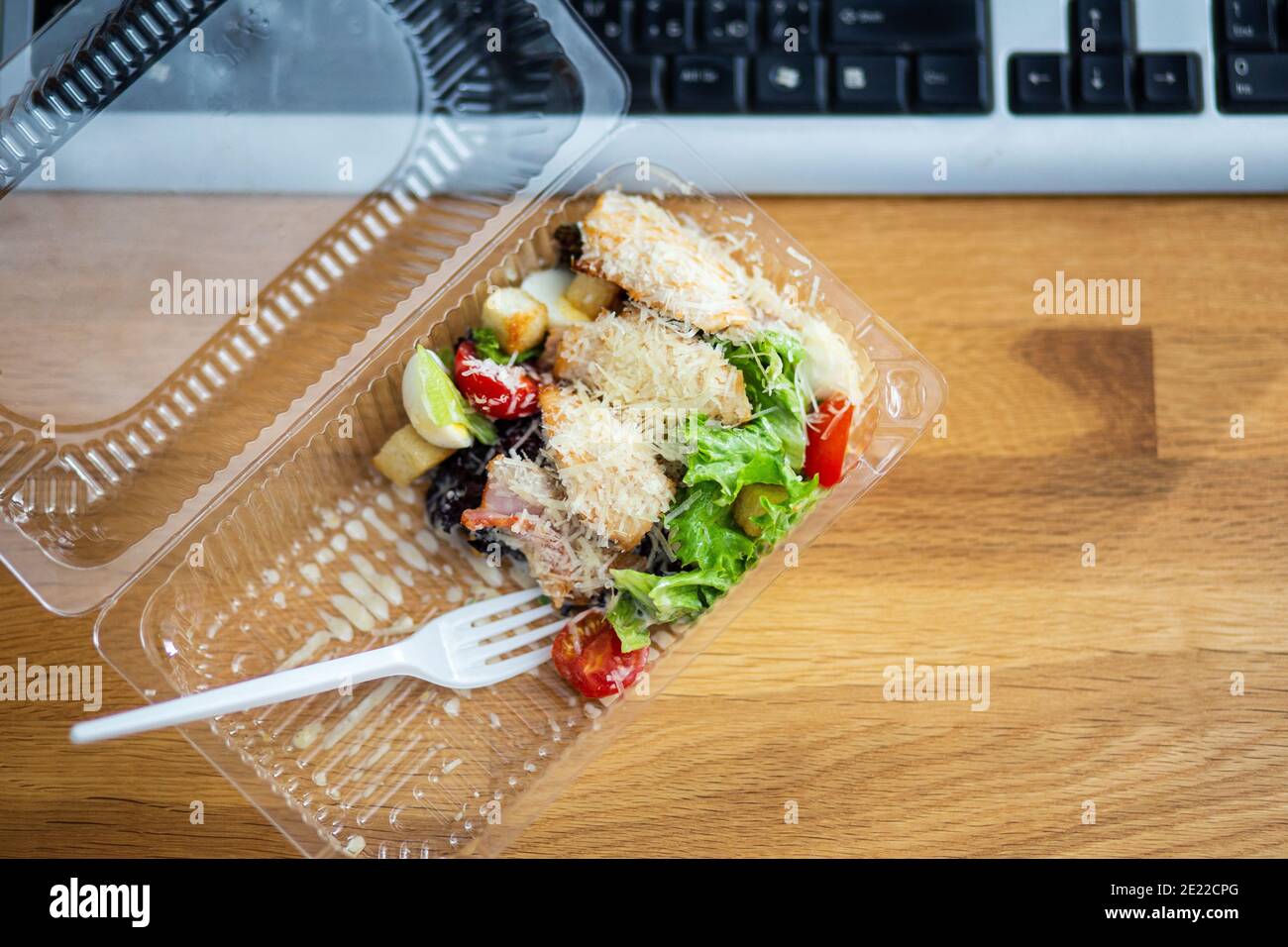 Delivery of takeout meal salad to workplace Stock Photo
