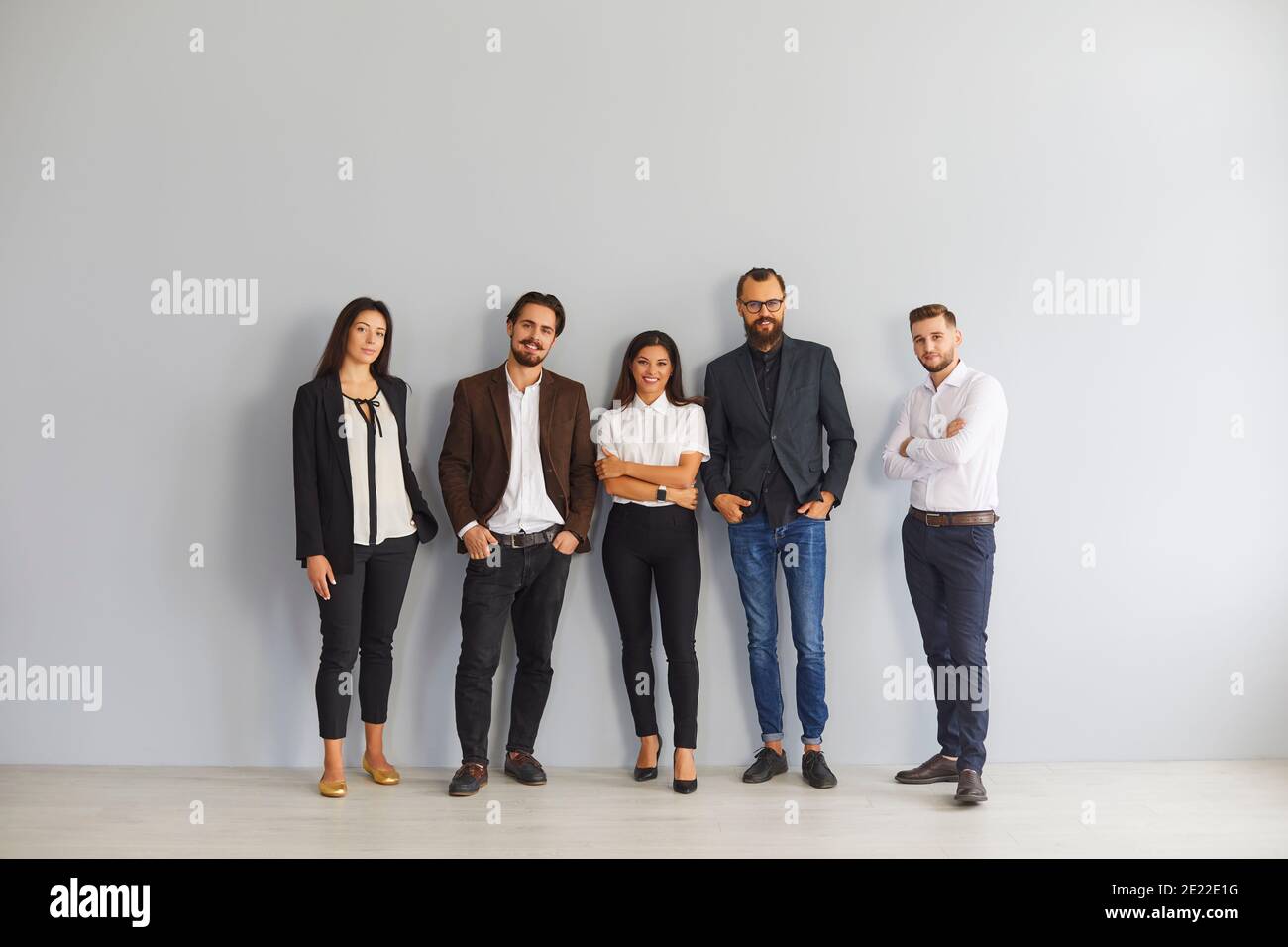 Group of smiling business people colleagues standing in office Stock Photo