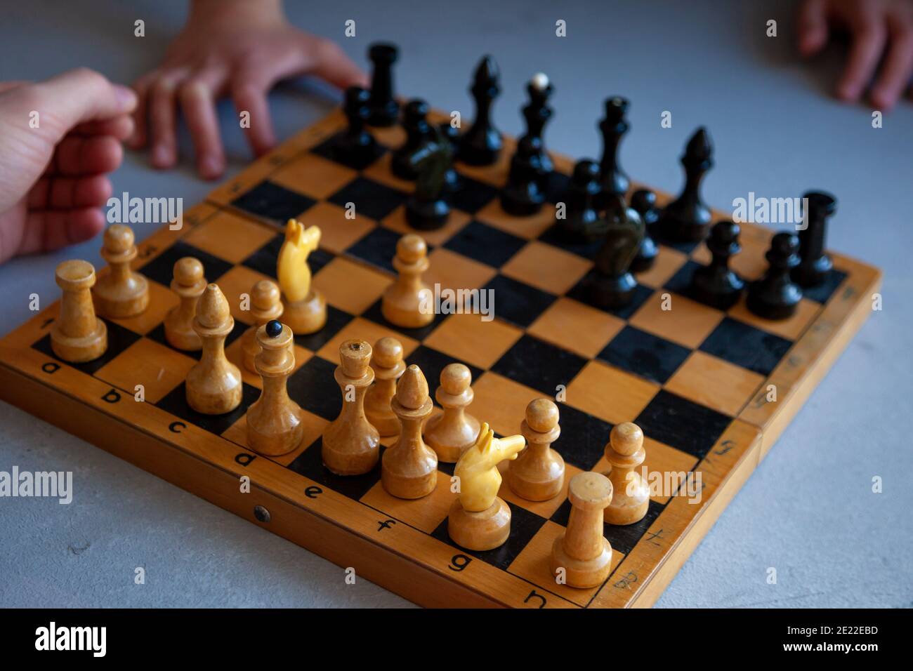 Premium Photo  Closeup of chess pieces on the chessboard under the lights  with a blurry background