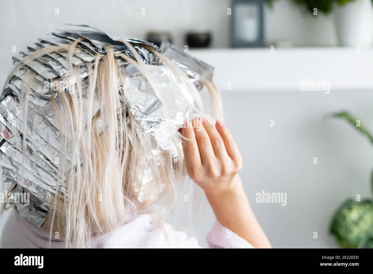 woman dyes her hair foil at home Stock Photo Alamy