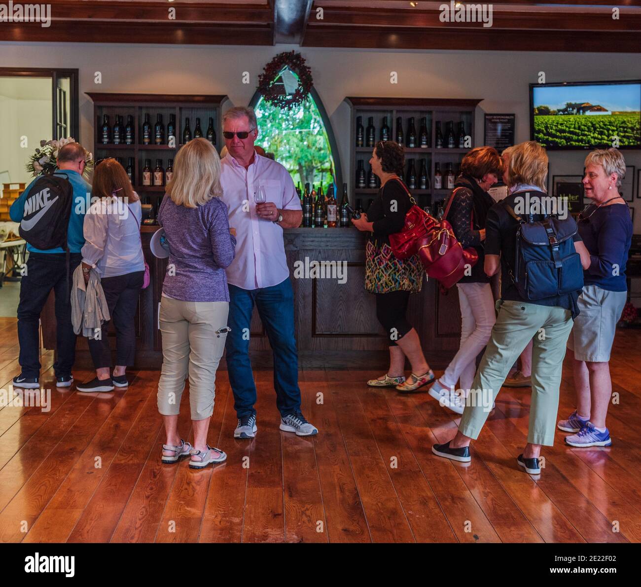 Abbey Cellars, Hawke's Bay, New Zealand -- February 27, 2018. Tourists sip wine in a tasting room at the Abbey Cellars Winery. Stock Photo