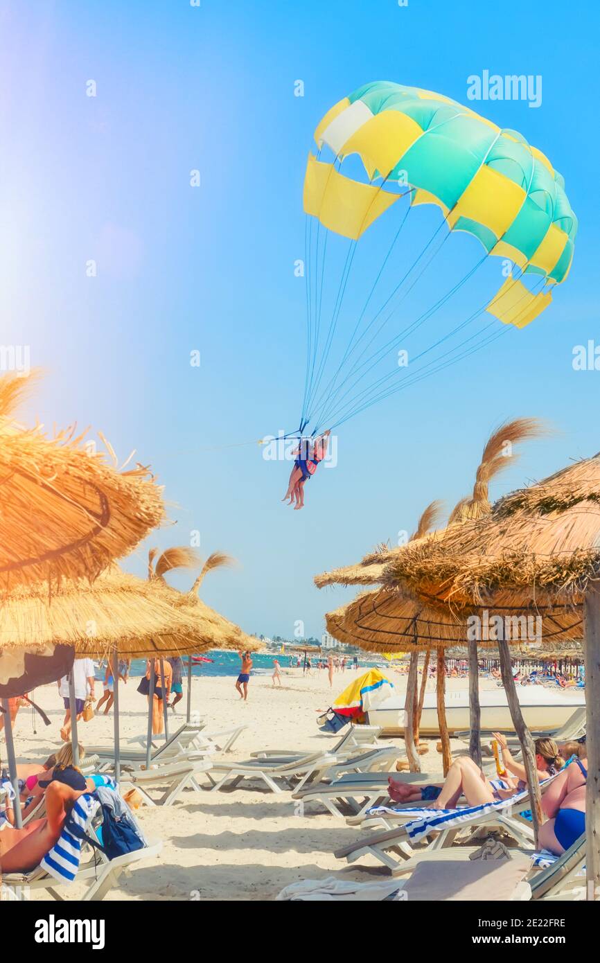 Parachute takes off from the beach, sea, umbrellas and tourists Stock