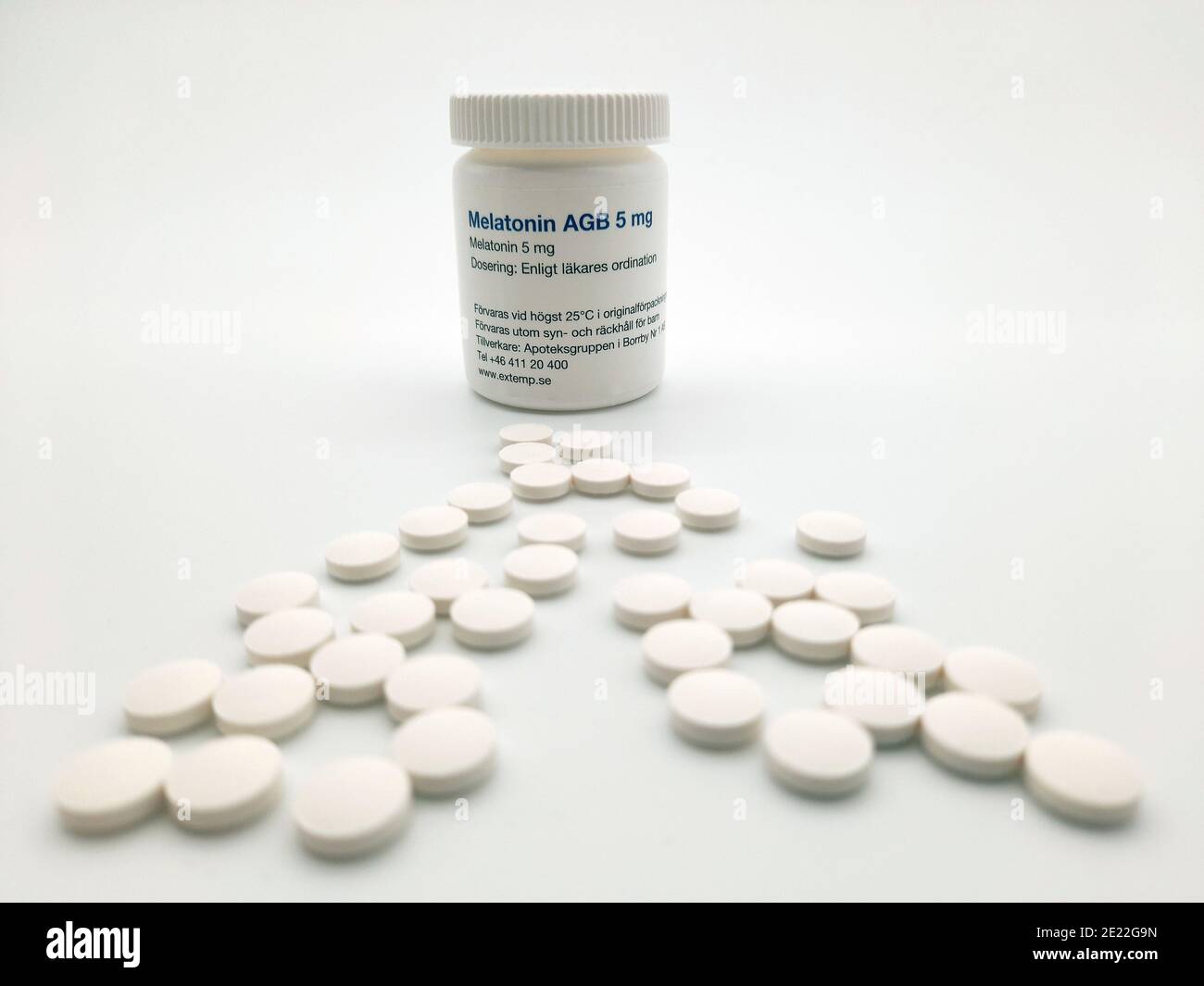 Stockholm, Sweden - January 10, 2021: A pill jar of Melatonin and the pills placed in front of the jar. Used perhaps to illustrate the increased presc Stock Photo