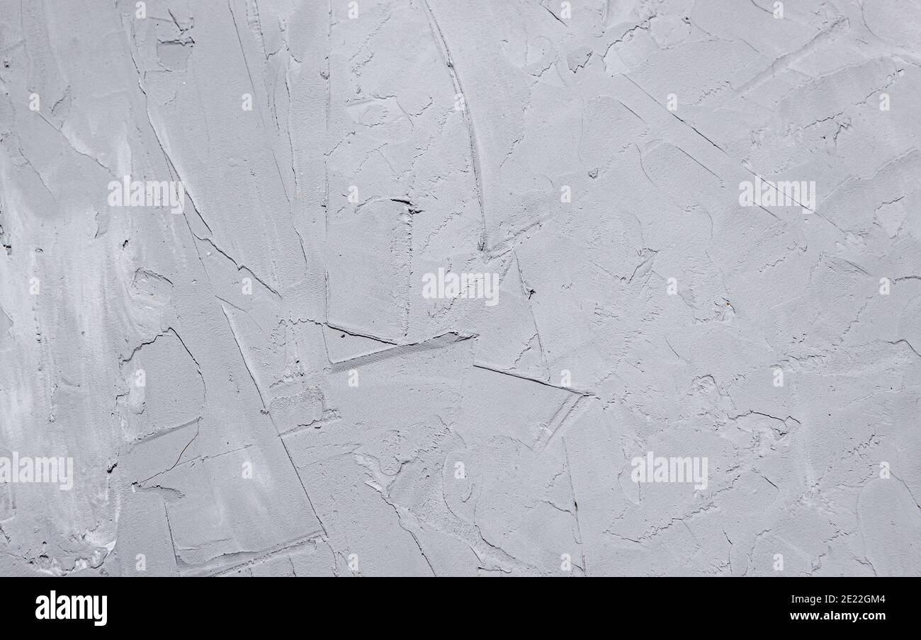 Concrete gray wall plastered with large rough strokes. The texture of the plaster close-up. Stock Photo