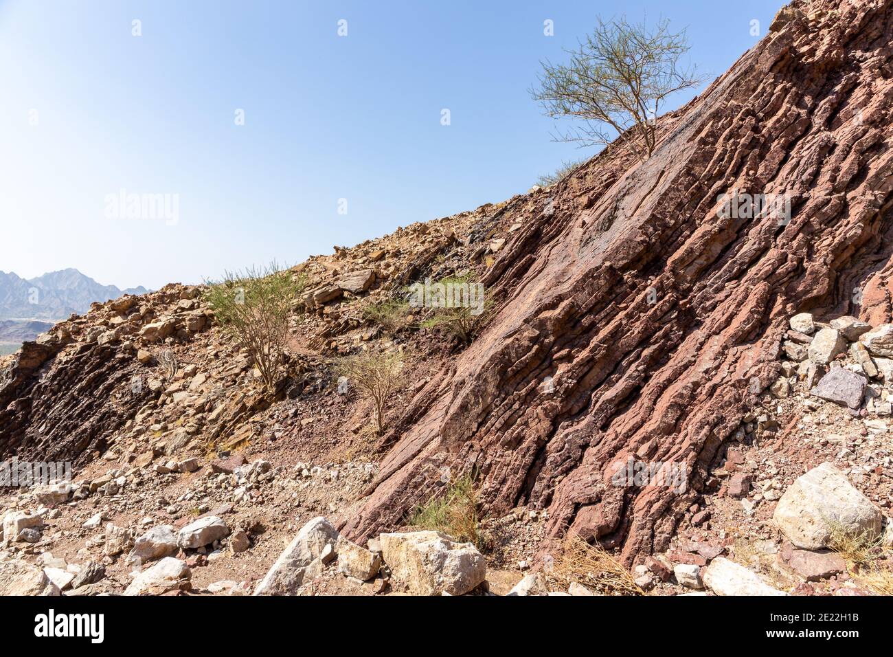 Red limestone and dolomite rock formations in Hajar Mountains on Arabian Peninsula, United Arab Emirates, Hatta. Stock Photo