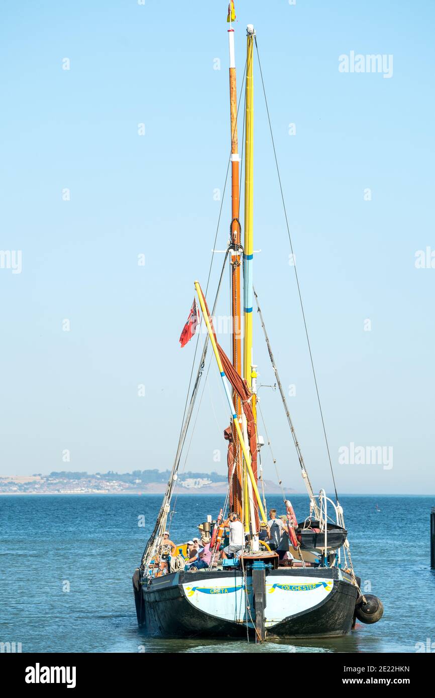 Colchester registered Thames sailing barge, Greta, leaving Whitstable harbour on a sunny day with a clear blue sky in the summer for a pleasure trip. Stock Photo