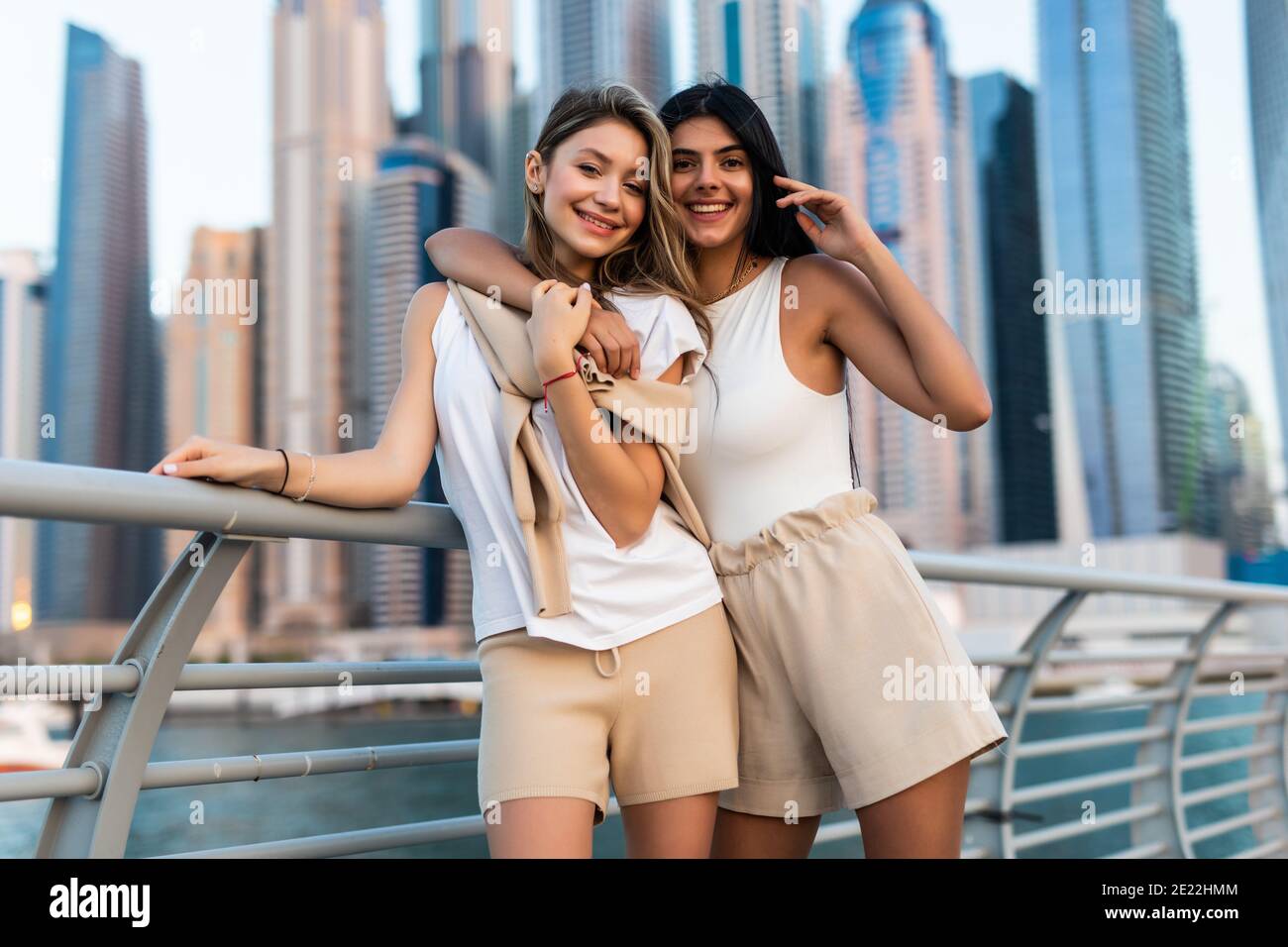 Two happy young women hugging and laughing outdoors Stock Photo - Alamy