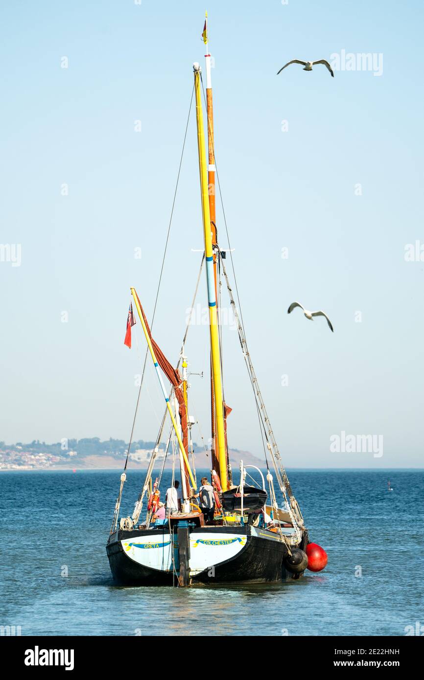 Colchester registered Thames sailing barge, Greta, leaving Whitstable harbour on a sunny day with a clear blue sky in the summer for a pleasure trip. Stock Photo
