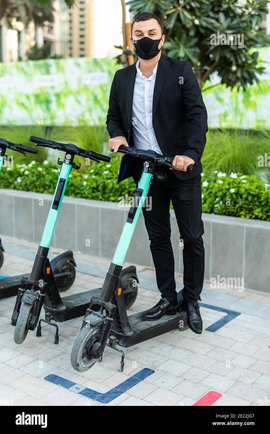 Man in suit on electric scooter hi-res stock photography and images - Alamy