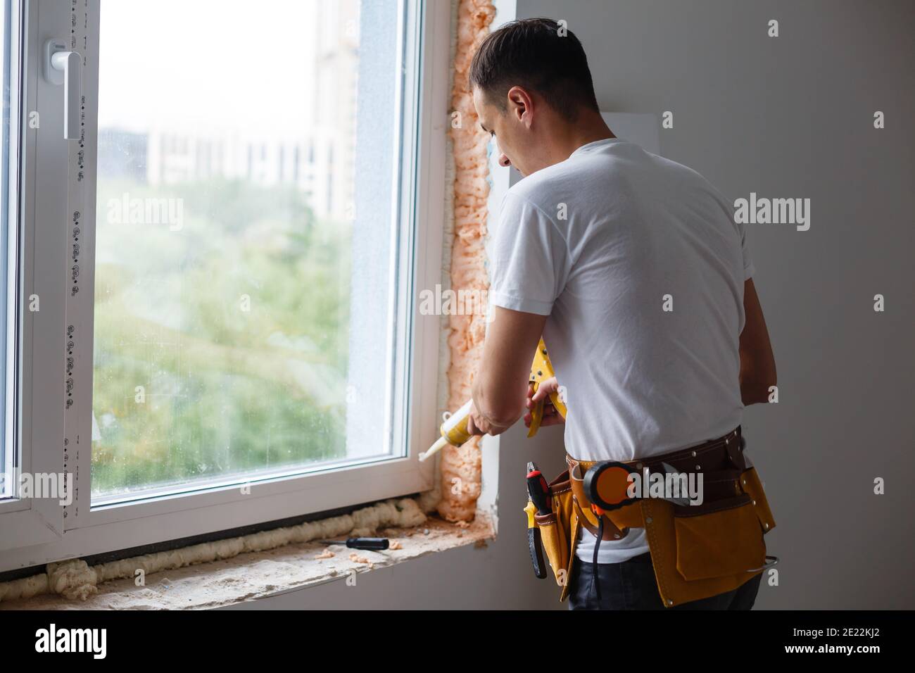 Caulking a new window frame Stock Photo Alamy