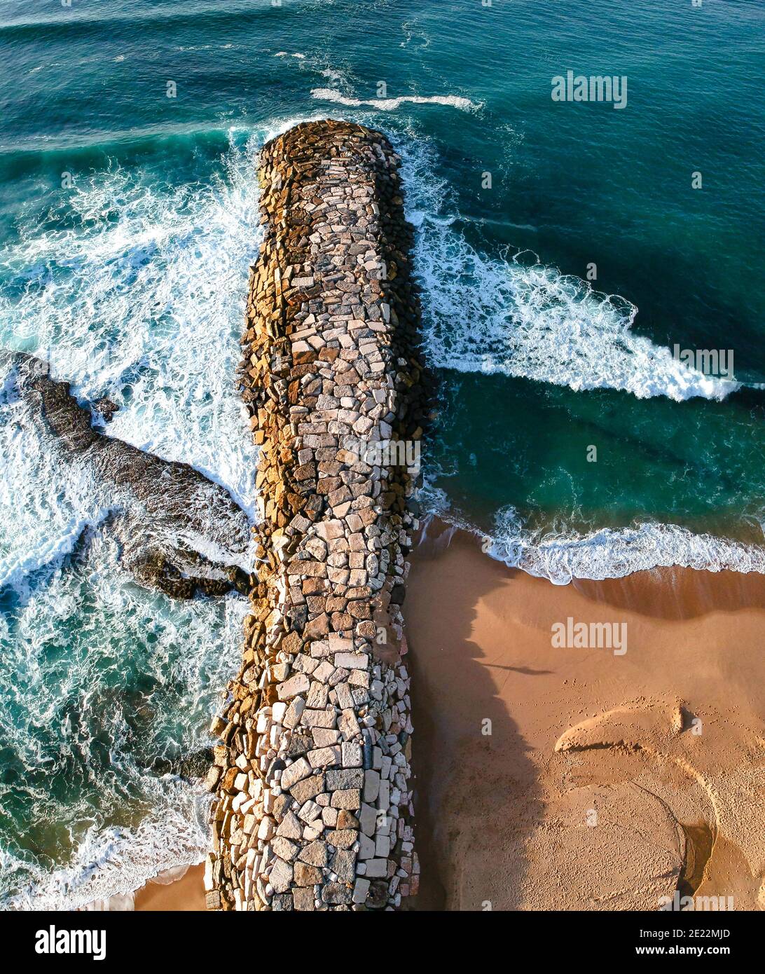 Aerial view from a stone jetty. Stone wave breaker blocks to protect t Stock Photo