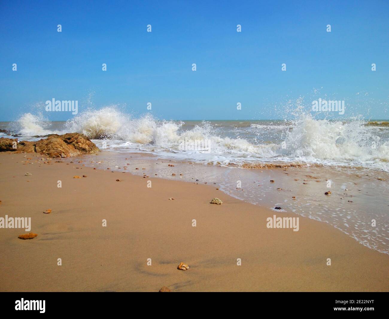 Strong Beach View of strong waves crashes over the beach on a clear sky background ...