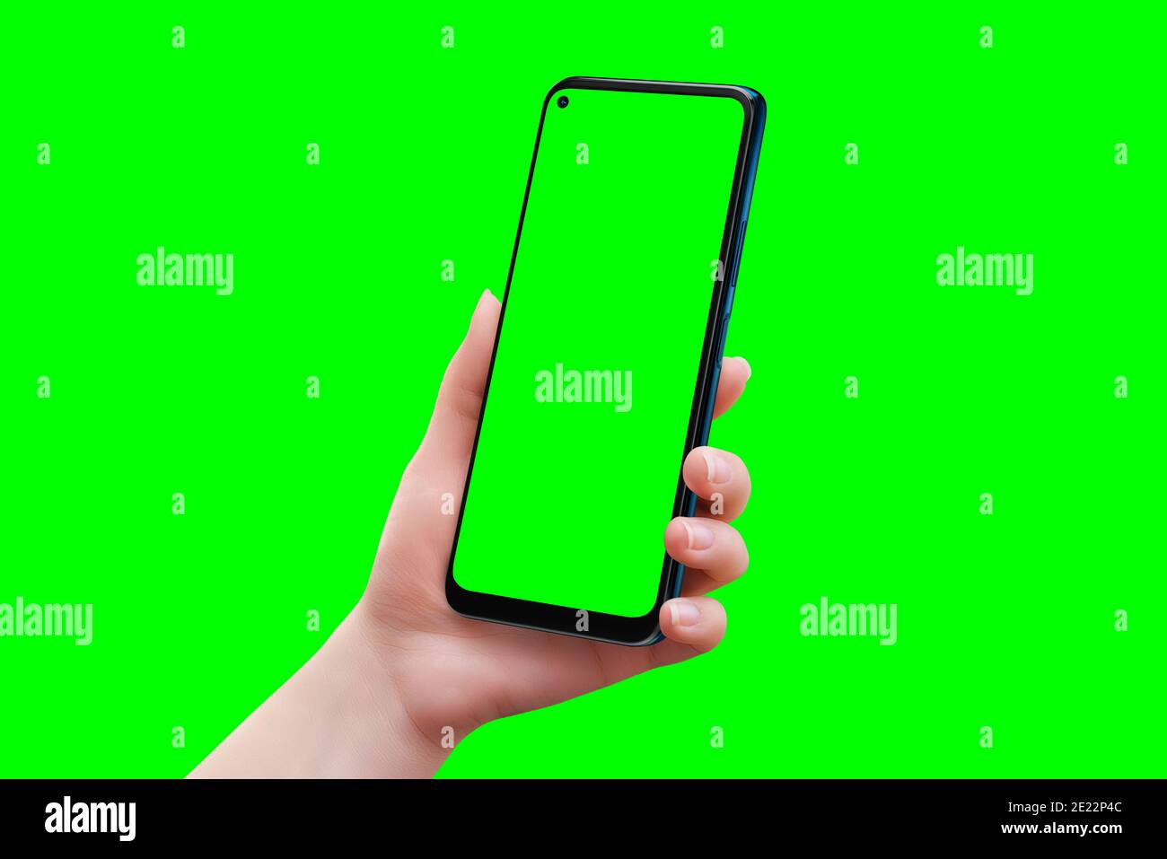 Phone mockup in woman hand isolated in chroma key green. Soft retouched woman hand Stock Photo