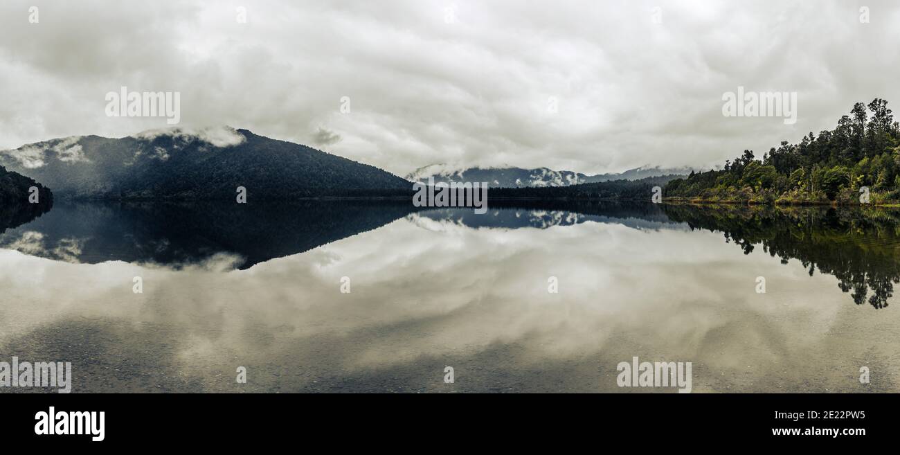 Clouds reflecting in a lake, South Island, New Zealand Stock Photo - Alamy
