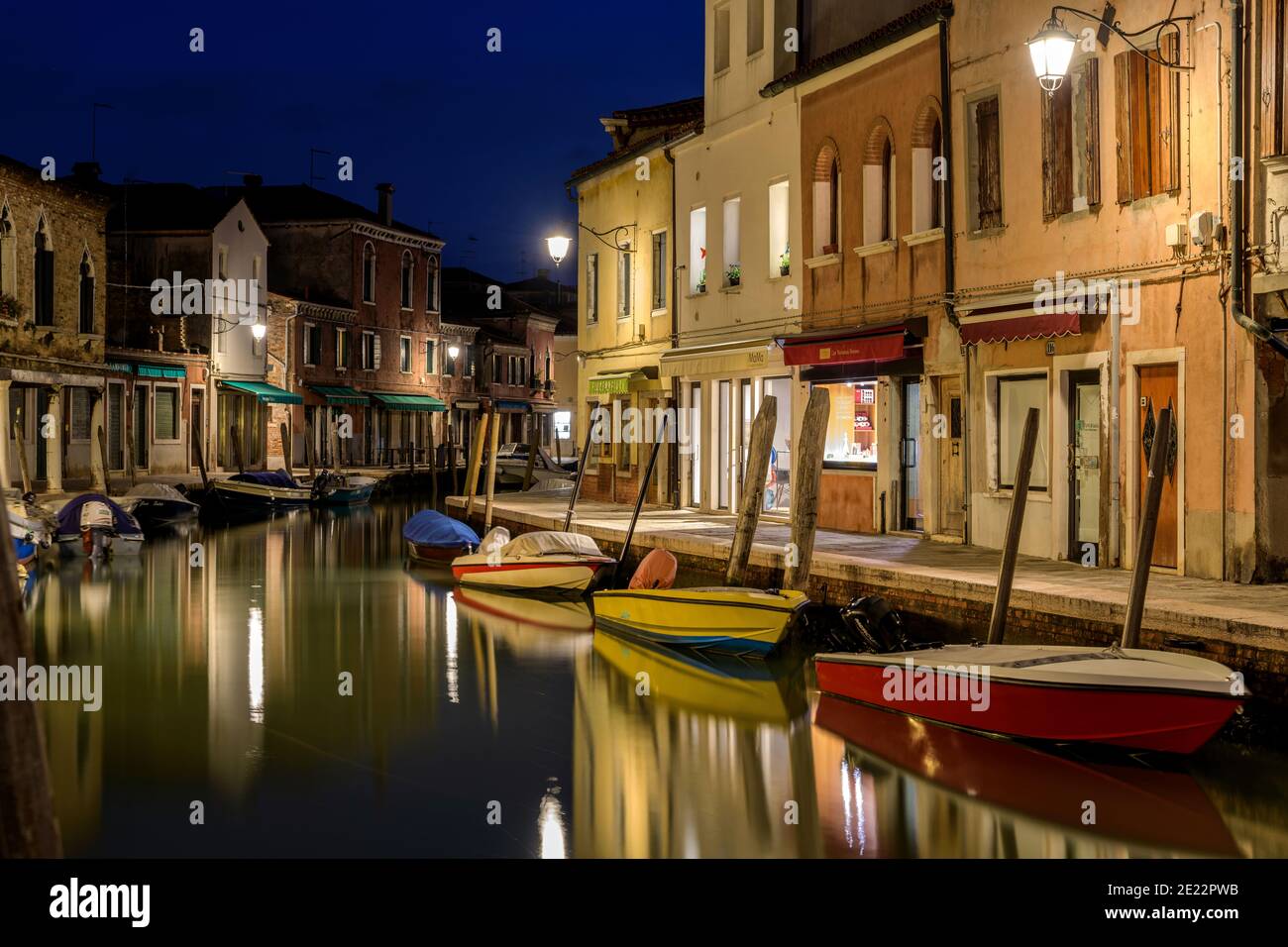 Night at Rio dei Vetrai - Night view of a colorful sidewalk along side of a narrow waterway, Rio dei Vetrai, on Murano Islands. Venice, Veneto, Italy. Stock Photo