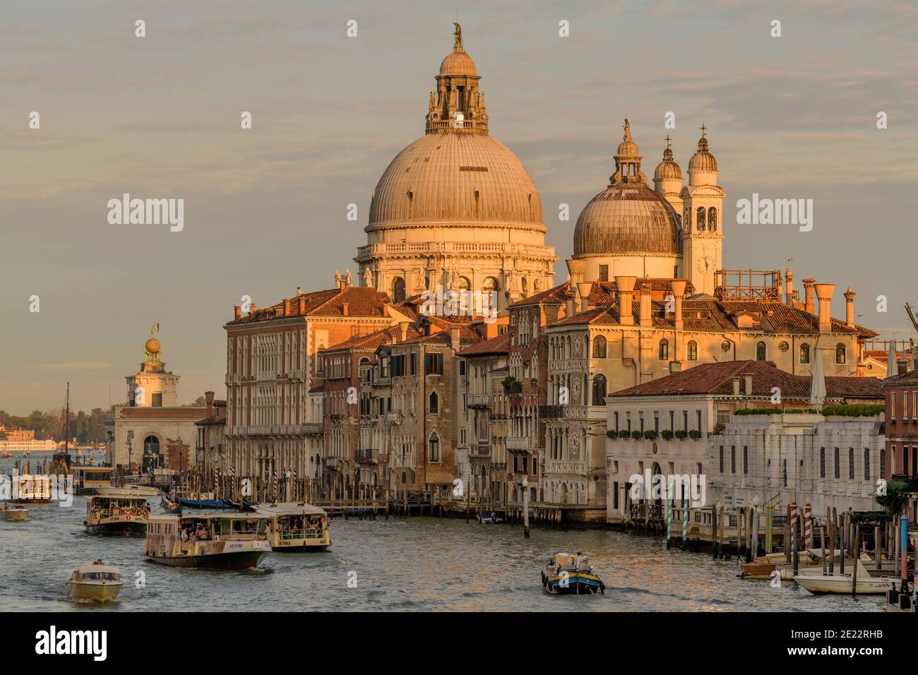 Sunset Grand Canal - Evening sunlight shines on domes of Basilica of Santa Maria della Salute, at south entrance of Grand Canal, Venice, Italy. Stock Photo