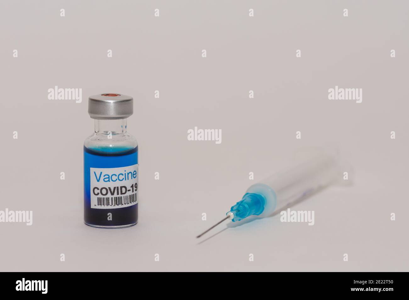 bottle with blue fluid and a syringe for coronavirus injection with ...