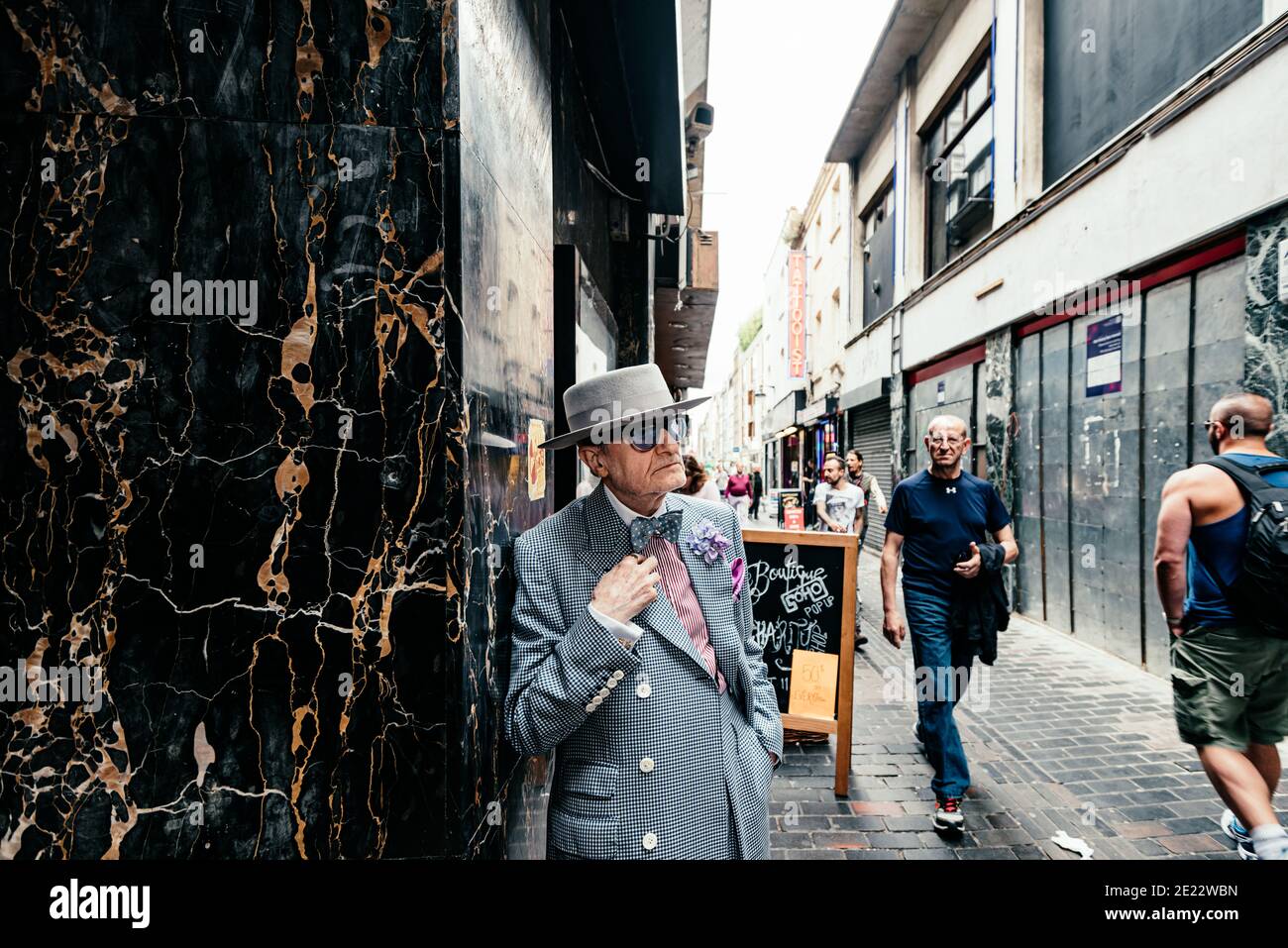 Artist George Skeggs ('Soho George') stands in Walker's Court, an alleyway joining Berwick St, Peter St and Brewer St, Soho, London, England, UK Stock Photo