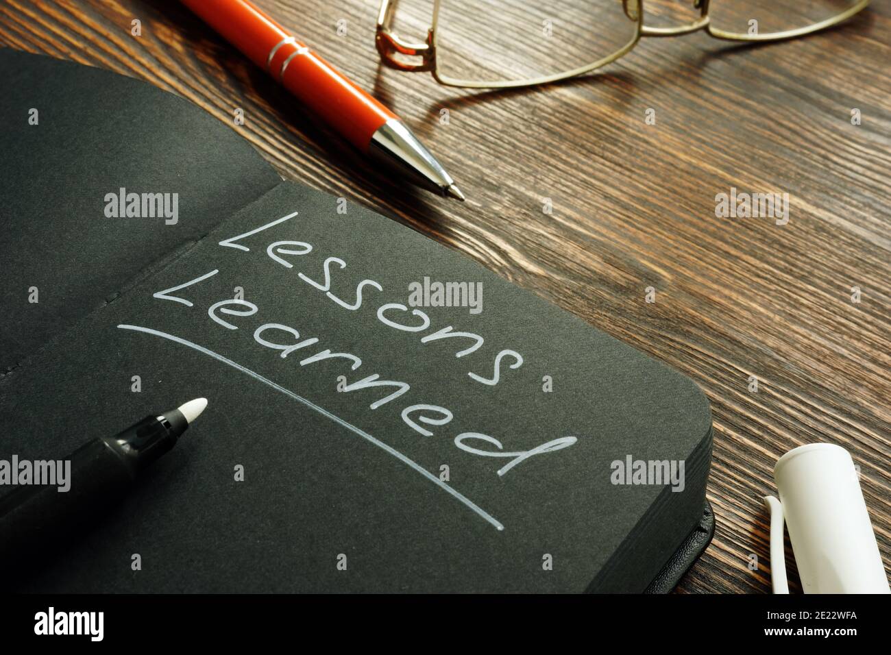 Lessons learned mark on the black page. Stock Photo