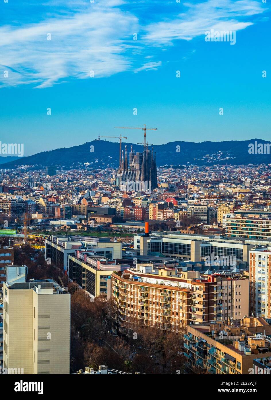 City of Barcelona cityscape with famous landmarks Torre Glories and La Sagrada Familia  towering above  - Barcelona, Catalonia, Spain Stock Photo