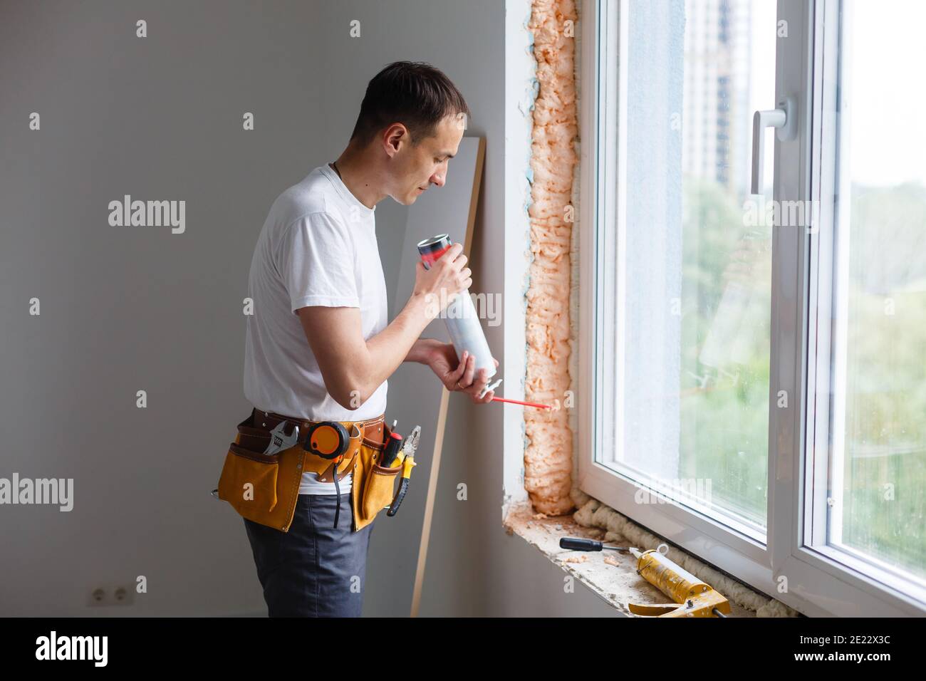 Caulking a new window frame Stock Photo Alamy