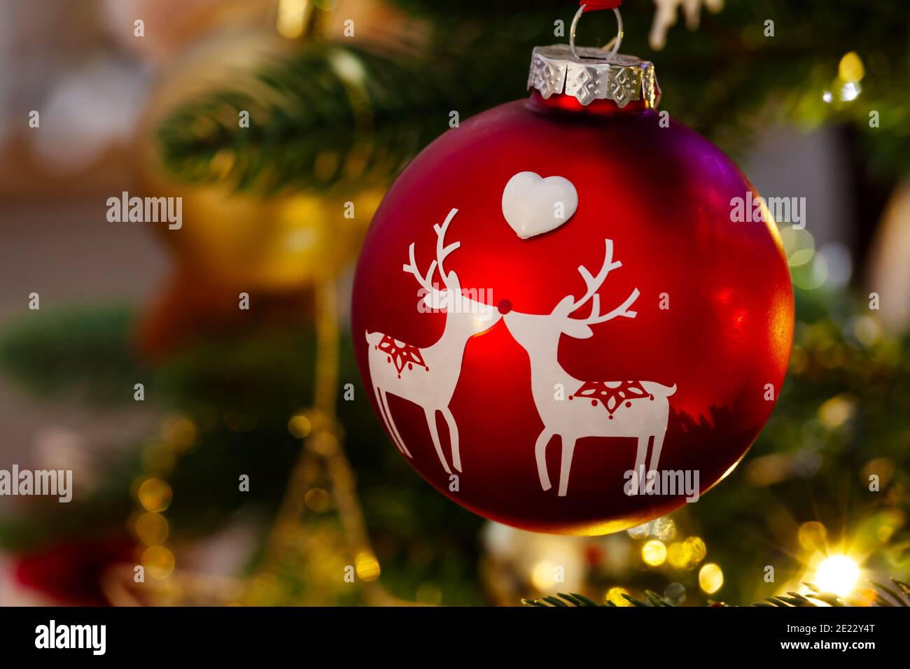 Reindeer christmas tree decoration, a red bauble hanging from a christmas tree Stock Photo