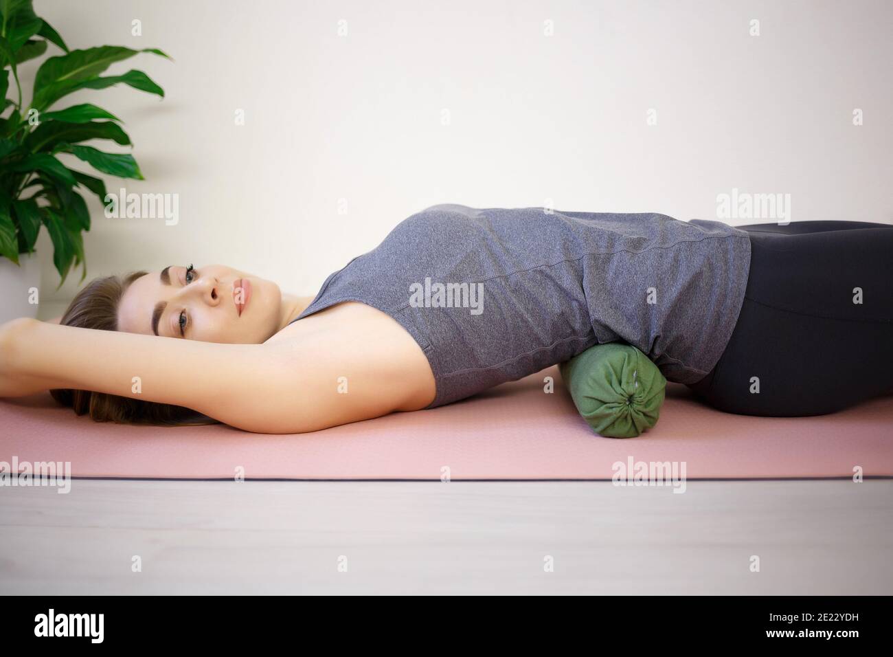 young woman doing exercises on a massage roller Stock Photo - Alamy