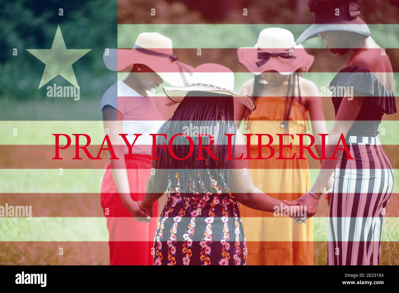 Pray for Liberia. Group of four african women holding hands and praying. Concept of crisis in Africa country. Stock Photo