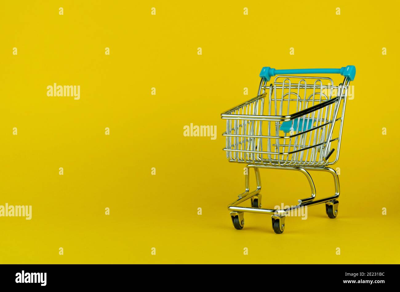 Empty shopping cart isolated on yellow background with empty space for text Stock Photo
