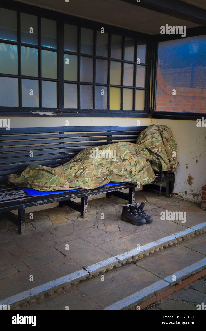 Homeless sleeping on the bench Stock Photo - Alamy