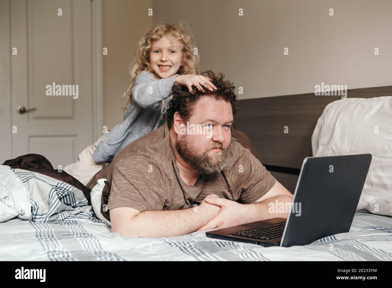 Work from home with kids children. Father working on laptop in ...