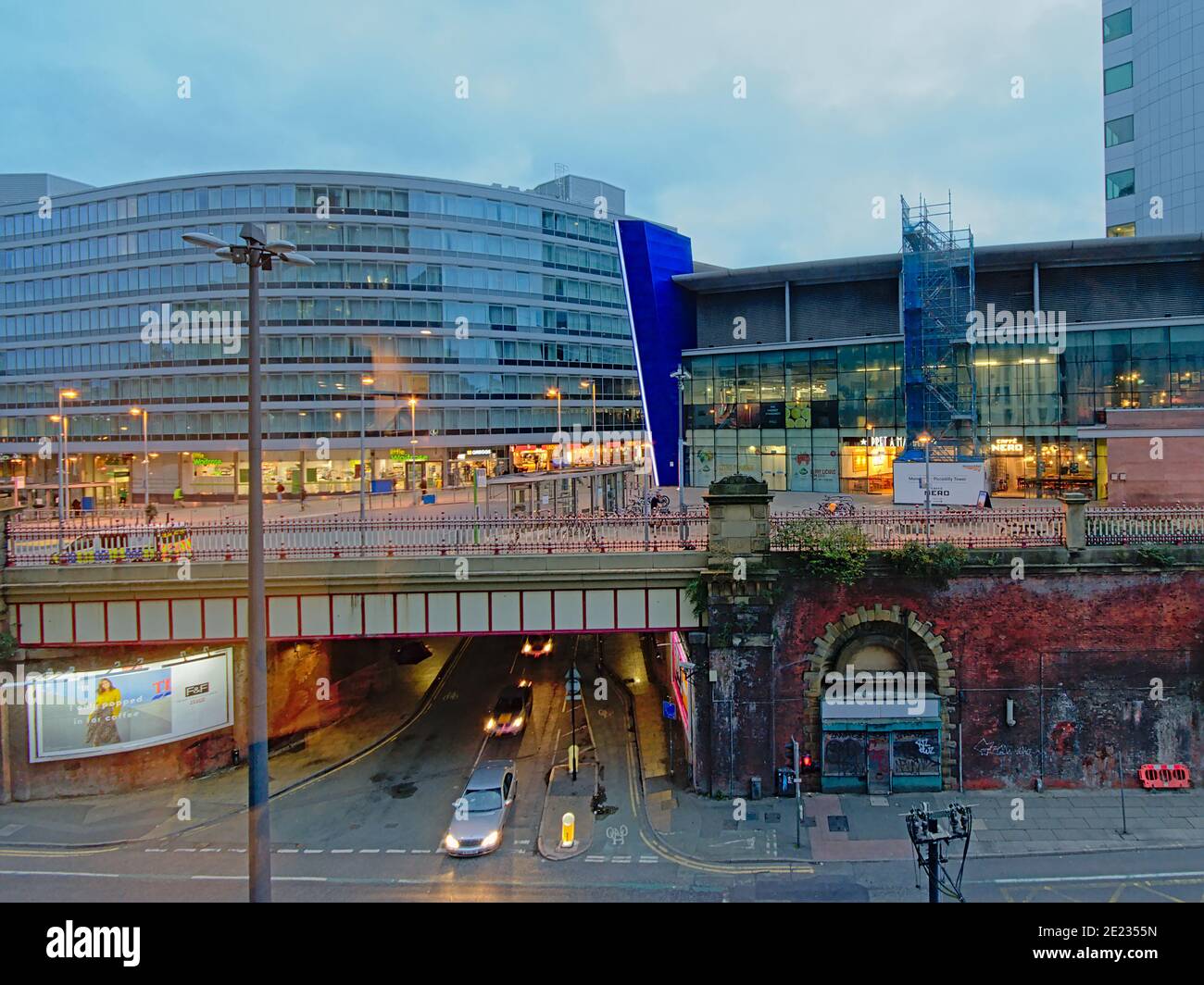 Streets of Manchester in two levels with tunnel below and shops and office buildings above in the early morning Stock Photo