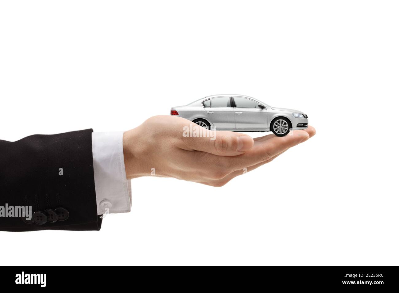 Male hand holding a silver model car isolated on white background Stock Photo
