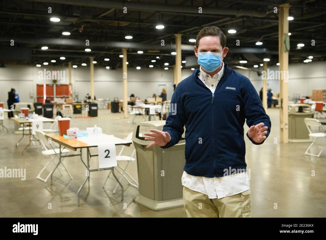Dallas, Texas, USA. 11th Jan, 2021. Dallas County TX Judge Clay Jenkins provides a walk-through of the mega-vaccination center process at the Dallas County COVID Mega-Vaccination Center in Fair Park, Dallas. He is standing near the tables where the vaccine will be administered to residents.The site is a joint effort between the city and county, will vaccinate up to 2,000 people a day, depending upon supply. The site opened as Texas shifts from smaller distribution sites to 'hubs'' that can vaccinate thousands a day. Credit: Avi Adelman/ZUMA Wire/Alamy Live News Stock Photo