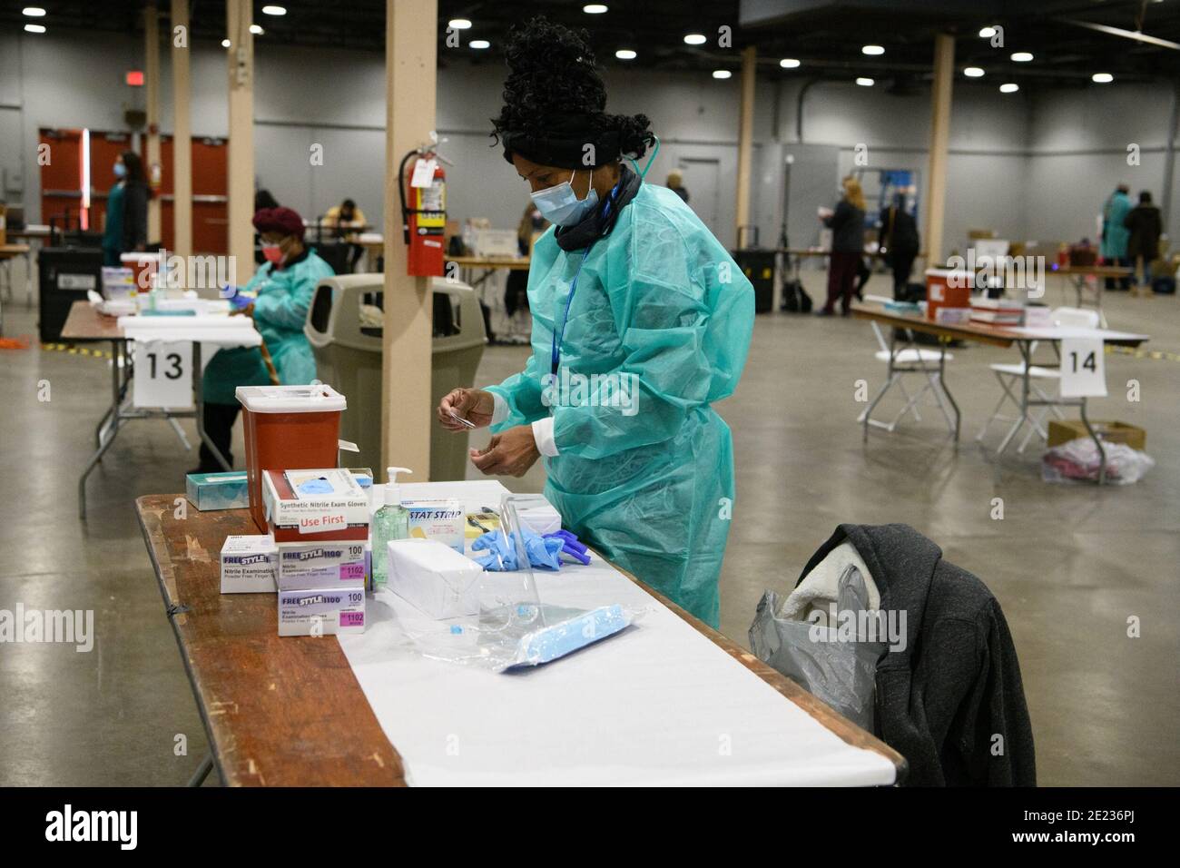Dallas, Texas, USA. 11th Jan, 2021. A Dallas County TX Health and Human Services staff member organizes the table where she will administer COVID vaccine to residents at Dallas County Fair Park mega-vaccination center in Fair Park.The site is a joint effort between the city and county, will vaccinate up to 2,000 people a day, depending upon supply. The site opened as Texas shifts from smaller distribution sites to 'hubs'' that can vaccinate thousands a day. Credit: Avi Adelman/ZUMA Wire/Alamy Live News Stock Photo