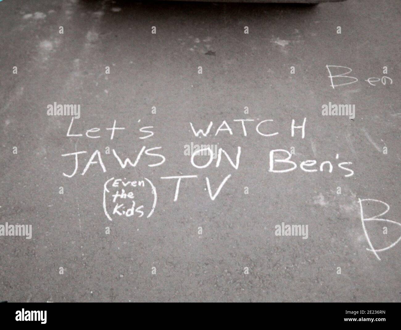 Weird Graffiti on the Ground - Let's Watch Jaws on Ben's TV, Even the Kids - circa late 1980s Stock Photo