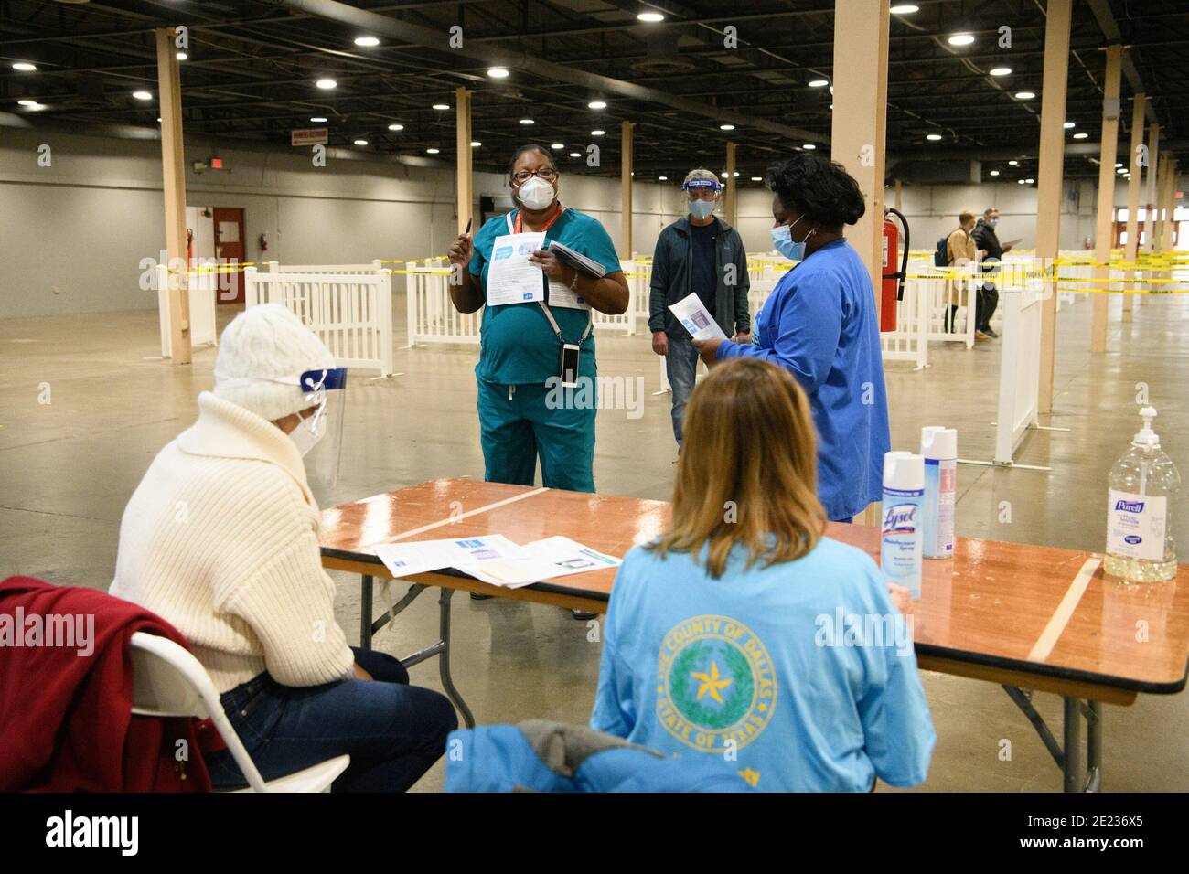 Dallas, Texas, USA. 11th Jan, 2021. A Dallas County TX Health and Human Services staff member reviews the paperwork process for staff and volunteers at the Dallas County Fair Park mega-vaccination center in Fair Park.The site is a joint effort between the city and county, will vaccinate up to 2,000 people a day, depending upon supply. The site opened as Texas shifts from smaller distribution sites to 'hubs'' that can vaccinate thousands a day. Credit: Avi Adelman/ZUMA Wire/Alamy Live News Stock Photo