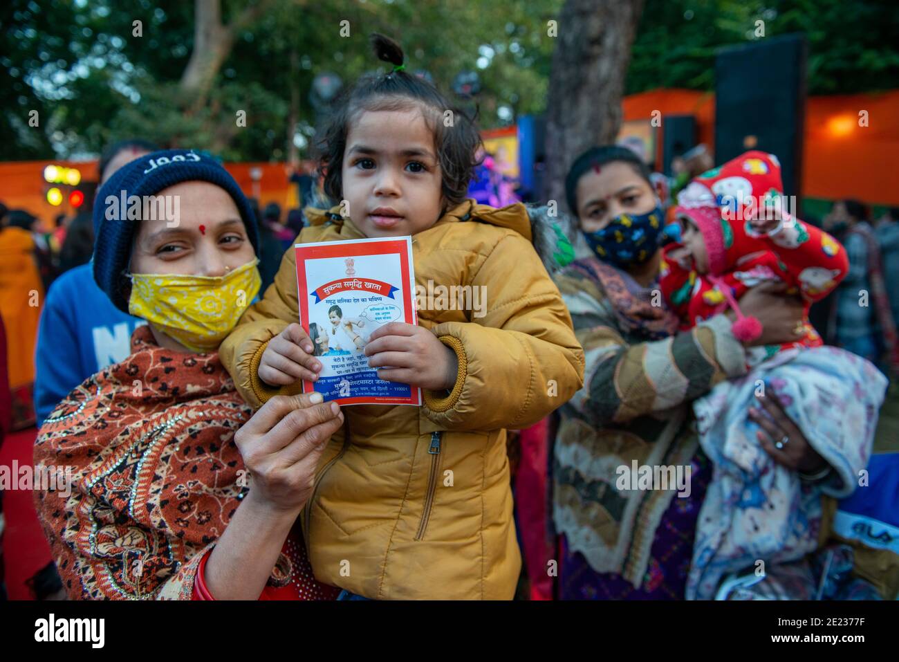 A Little Girl Along With Her Mother Hold A Passbook Of Sukanya a-little-girl-along-with-her-mother-hold-a-passbook-of-sukanya