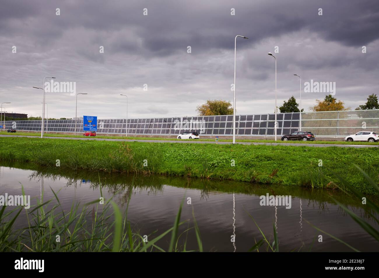 Solar panels on a noise barrier along a motorway Stock Photo Alamy